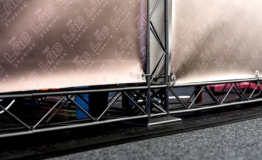 Detail of the frame base meeting the stand floor and the hall carpet