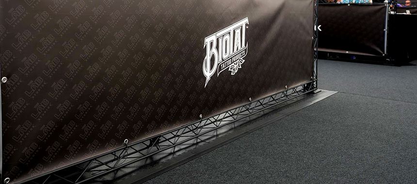 A long run of black fascia graphics on lattice frame