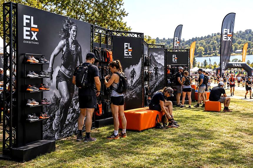 Trail running brand activation on grass beside a lake